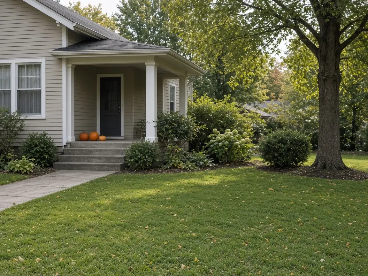 A quiet front yard with pumpkins on the step and no inflatable figures